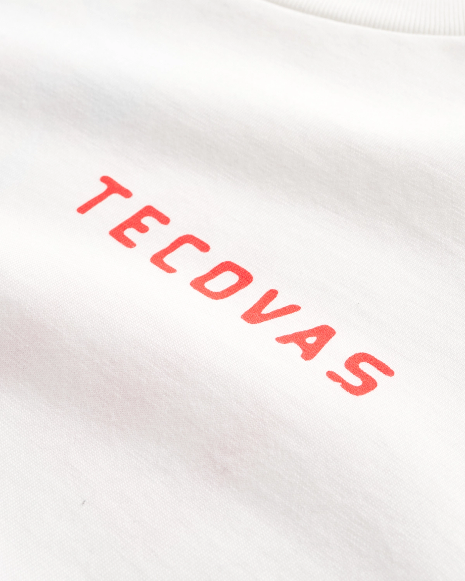 White fabric with the word "TECOVAS" printed in red, capital letters in a simple font.