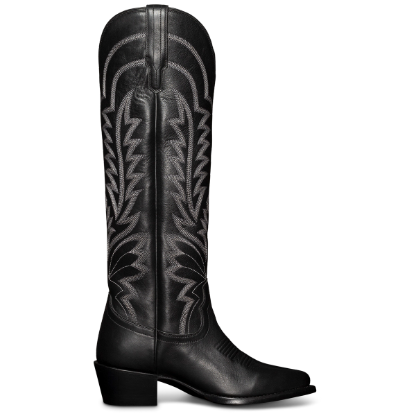 A tall black cowboy boot with intricate white stitching and a low heel, viewed from the side.
