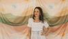 Kelly Colchin in a white spring dress and white cowgirl boots The Annie.