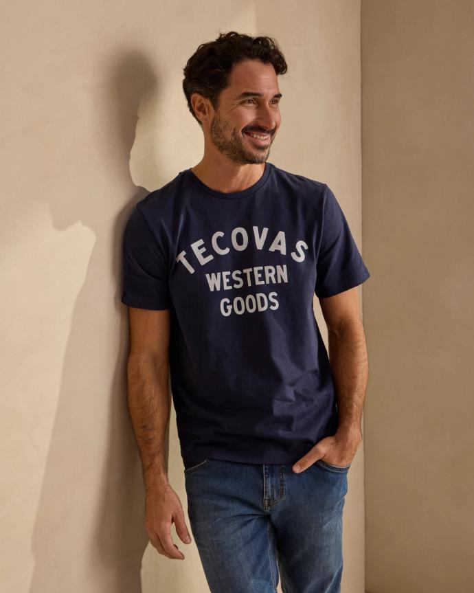 Man wearing a Navy Western Goods Tecovas T Shirt. 