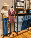 Interior of a boot store with shelves of various styles of western clothing 