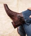 close up picture of Cole Mahogany brown cowboy boots on a man's feet