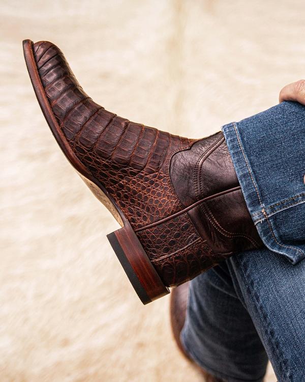 close up picture of Earl Mahogany brown cowboy boots on a man's feet