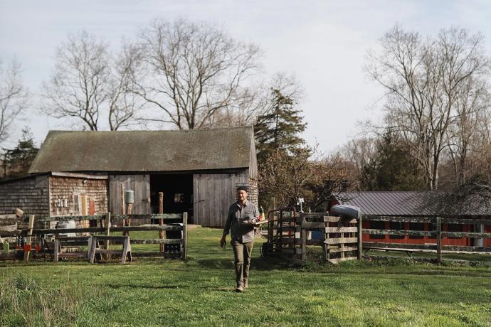 man walking through a farm gate