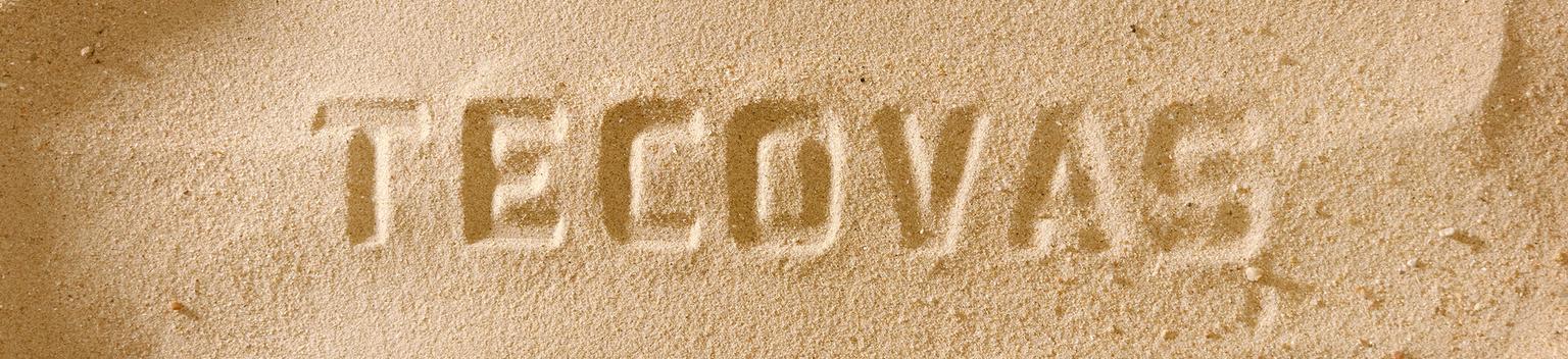 The word "TECOVAS" is written in capital letters in the sand.