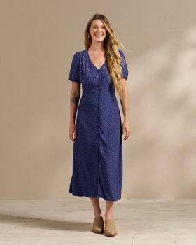 Woman wearing a long blue floral dress in a photo studio