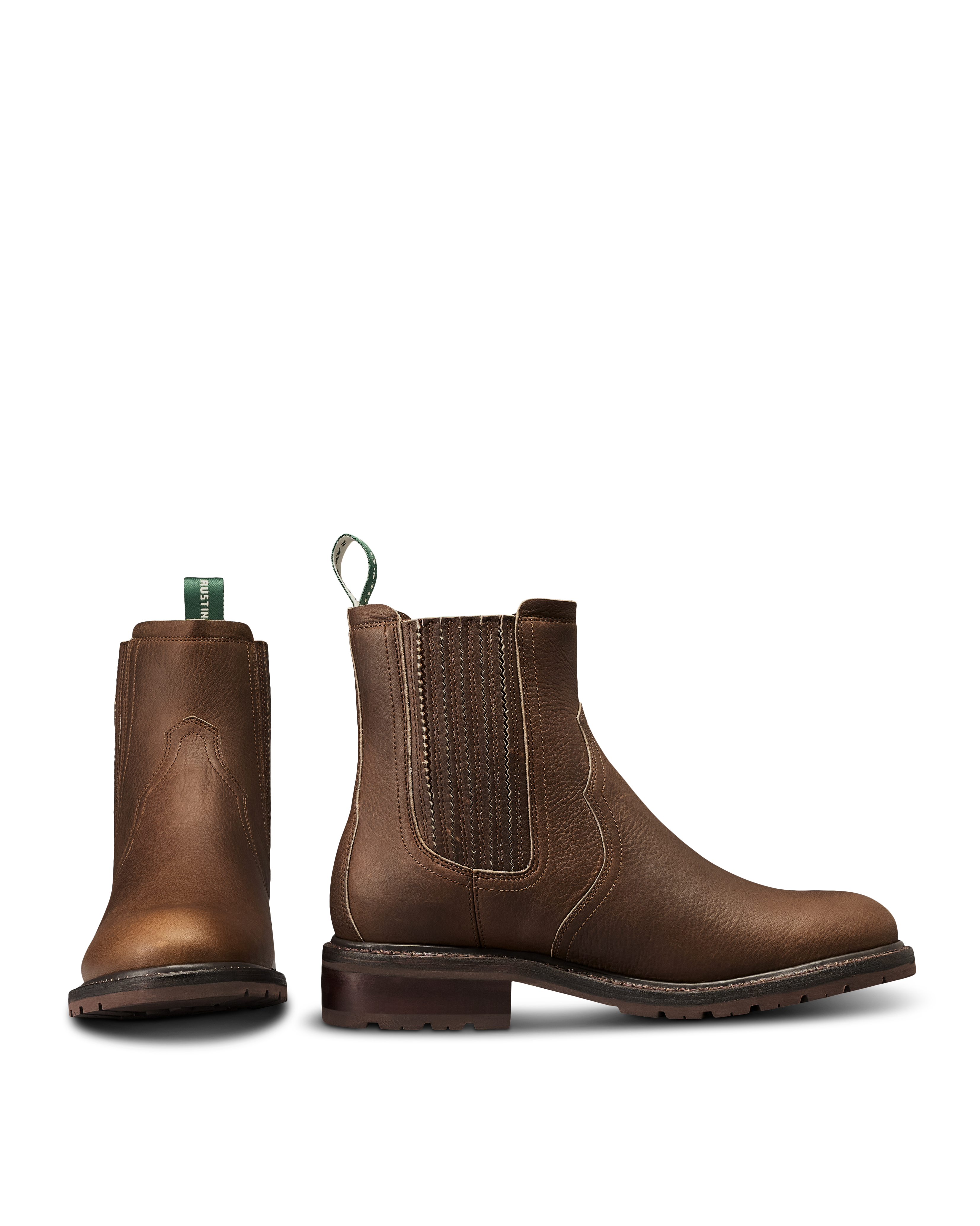 The Chelsea in Cafe Cowhide. Pair of brown leather Chelsea boots crafted from premium Cafe Cowhide with elastic side panels, front and side view shown, featuring pull tabs and low heels.