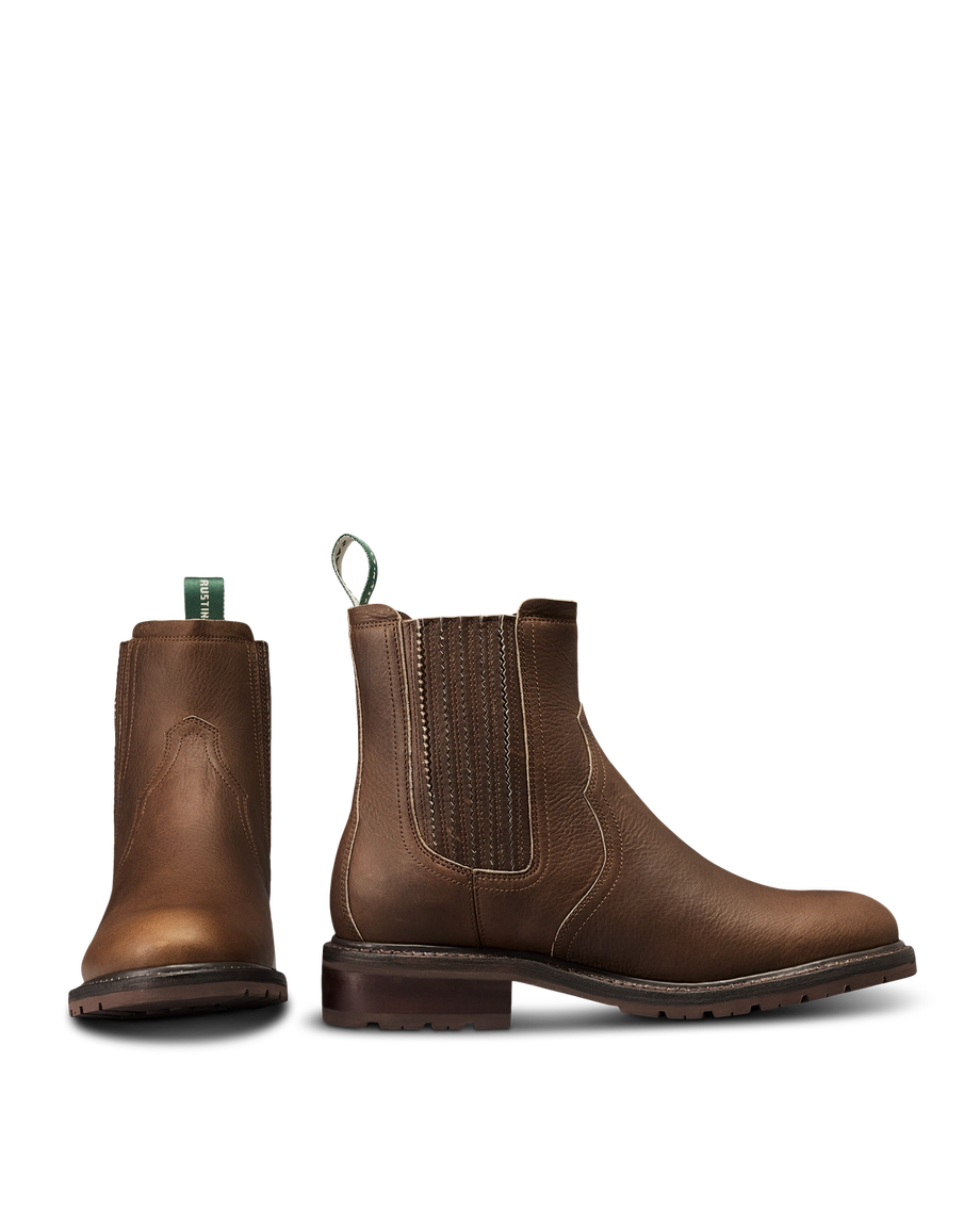 The Chelsea in Cafe Cowhide. Pair of brown leather Chelsea boots crafted from premium Cafe Cowhide with elastic side panels, front and side view shown, featuring pull tabs and low heels.