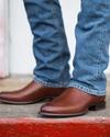close up picture of Earl bourbon brown cowboy boots on a man's feet