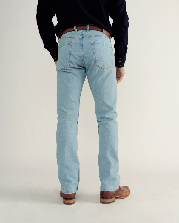 Back view of Men's Slim Straight Stretch Denim - Light Stone Wash on model
