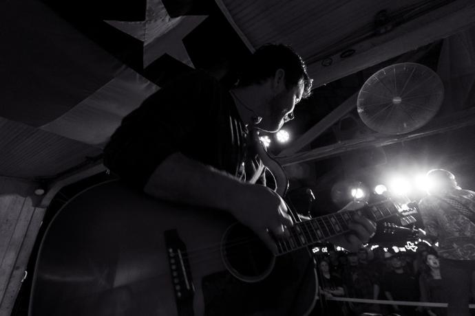 black and white photo of a man playing guitar