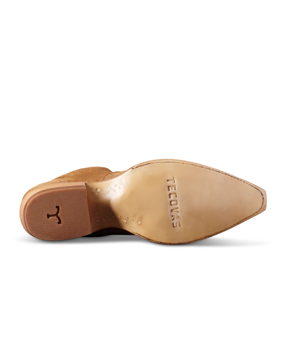 The image shows the sole of a brown leather shoe with the brand name "Tecovas" and a small logo imprinted on it.