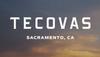 The image displays the word "Tecovas" in large white letters with "Sacramento, CA" underneath against a dusk sky background.