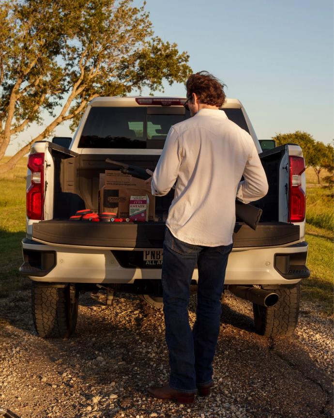 Back view of a man behind his truck.