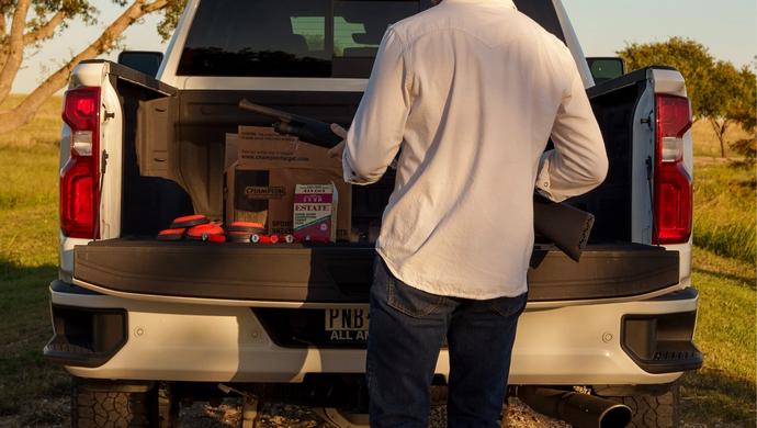 Back view of a man behind his truck.