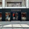 Front view of a Tecovas store in a shopping mall, with glass doors and windows, and Gucci and Burberry stores visible on the upper level.