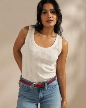 Woman wearing the white ribbed tank in a photo studio
