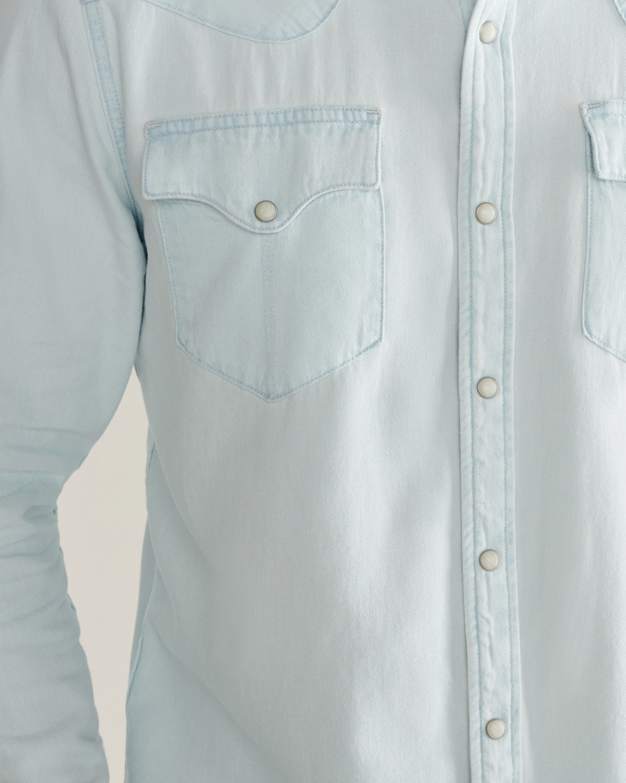 Closeup detail view of Men's Denim Long Sleeve Pearl Snap - Ultra Light
