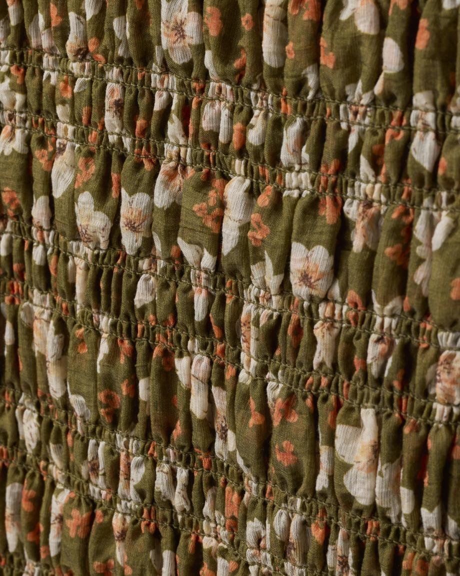 close up view of The Emma Dress by Kristopher Brock - Olive/Beige Floral Cotton Blend on plain background