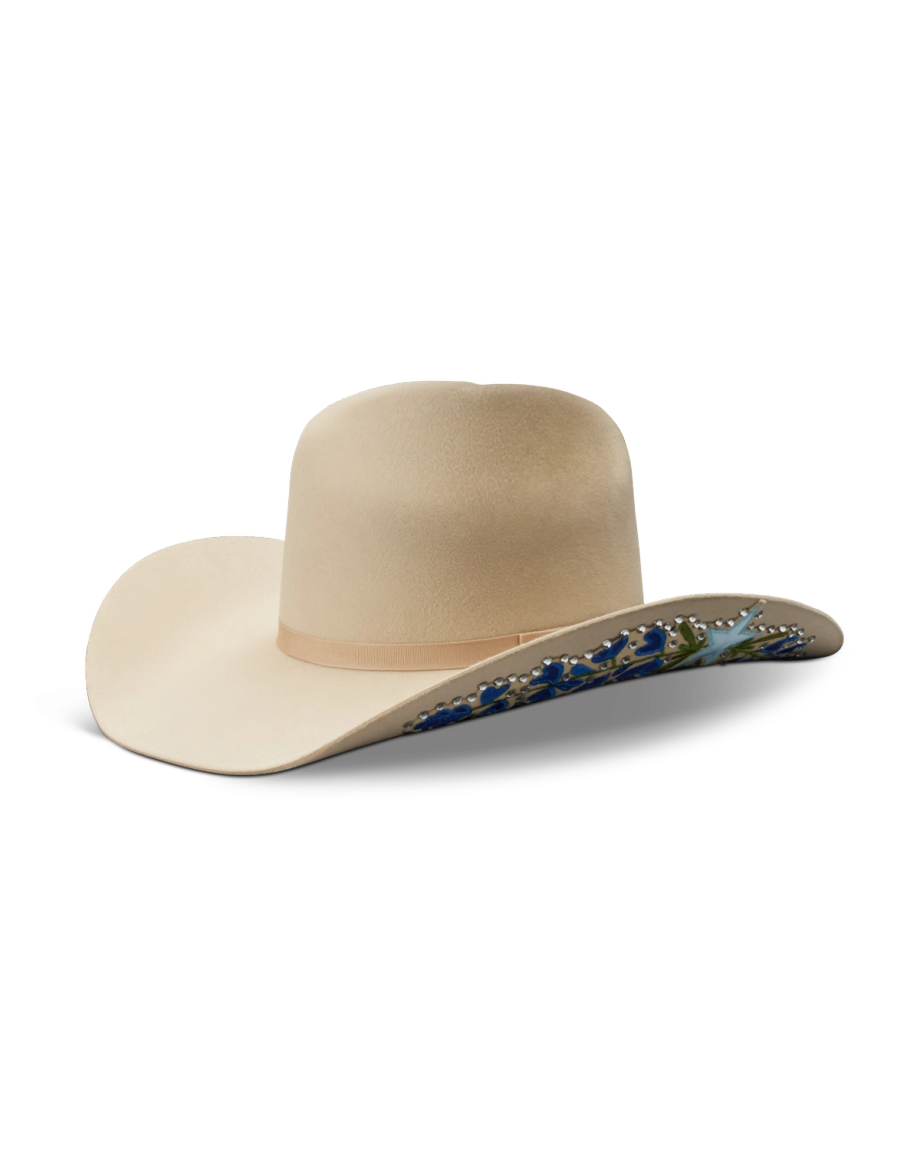 A beige cowboy hat with a wide brim and decorative blue floral patterns on the underside.