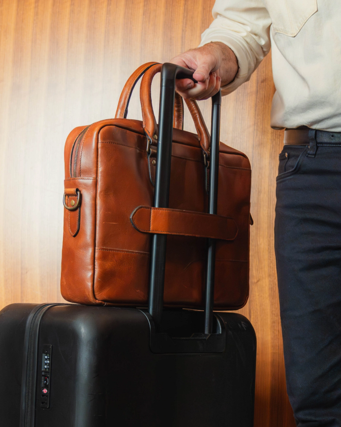 The Bartlett Slim Briefcase over a carryon suitcase.