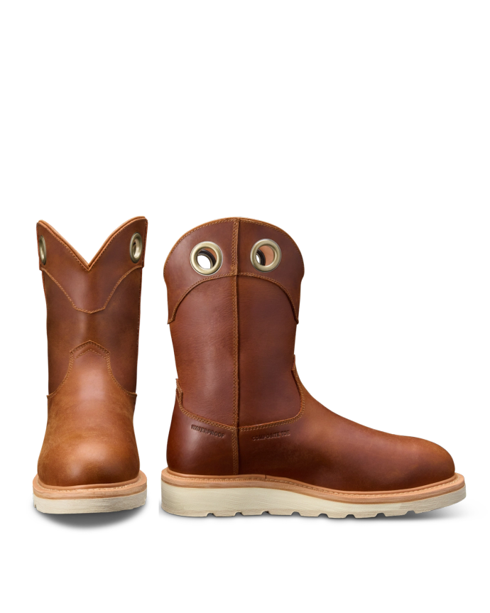 A pair of brown leather boots with rounded toes and cream-colored soles, featuring pull-on grommets near the top.