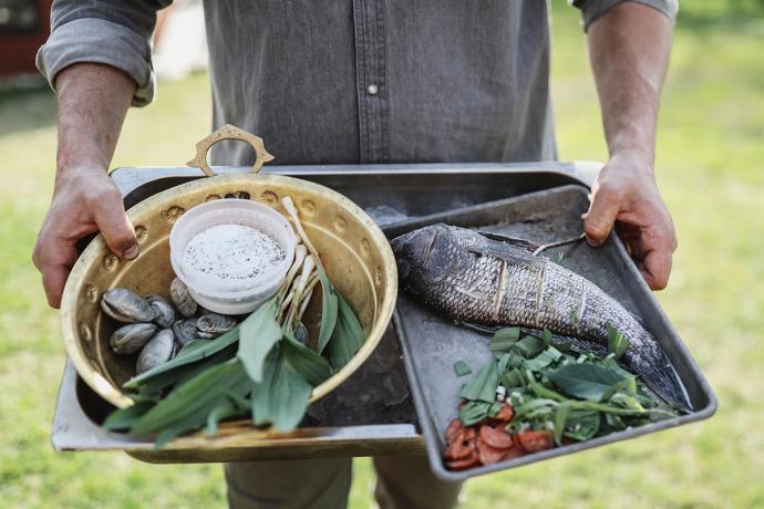 man preparing a fish to cook