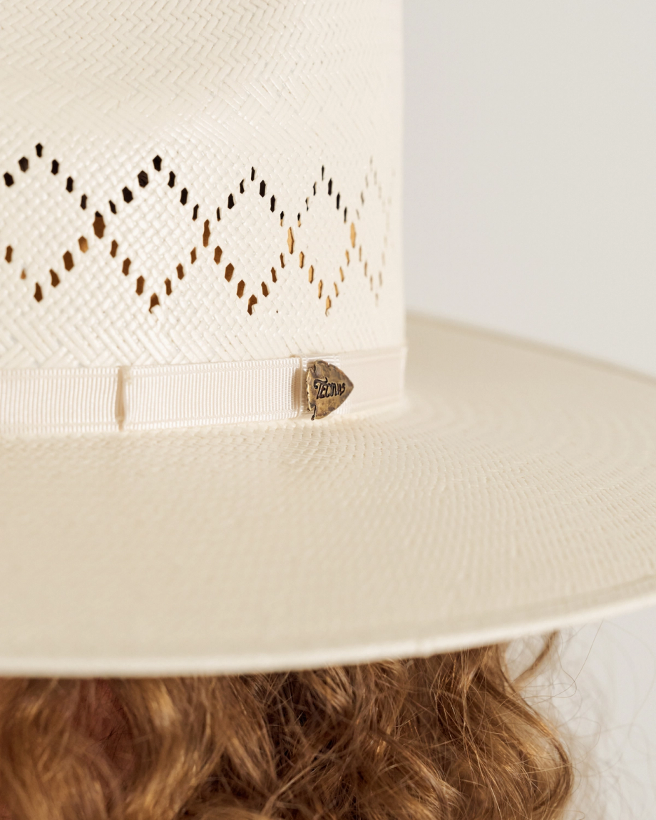 Closeup of woman wearing a straw hat in a photo studio