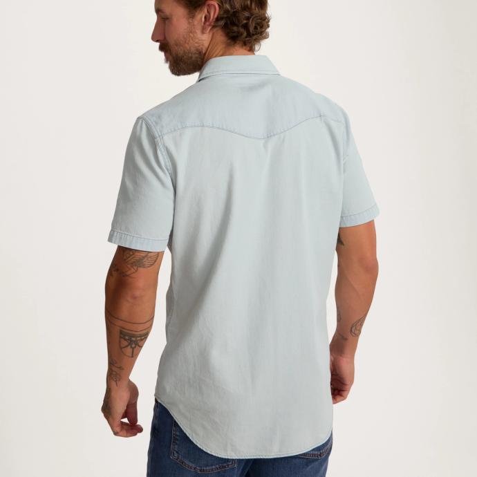 Man wearing light blue denim pearl snap short sleeve button down