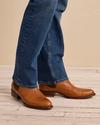 Lifestyle image of a man wearing the Chance chelsea boots in brandy brown