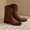 Roper boots on white wash wood floor