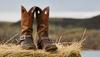 Image of weathered cowboy boots on a bale of hay