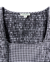 Close-up of a black and white checkered smocked top with a Tecovas label.