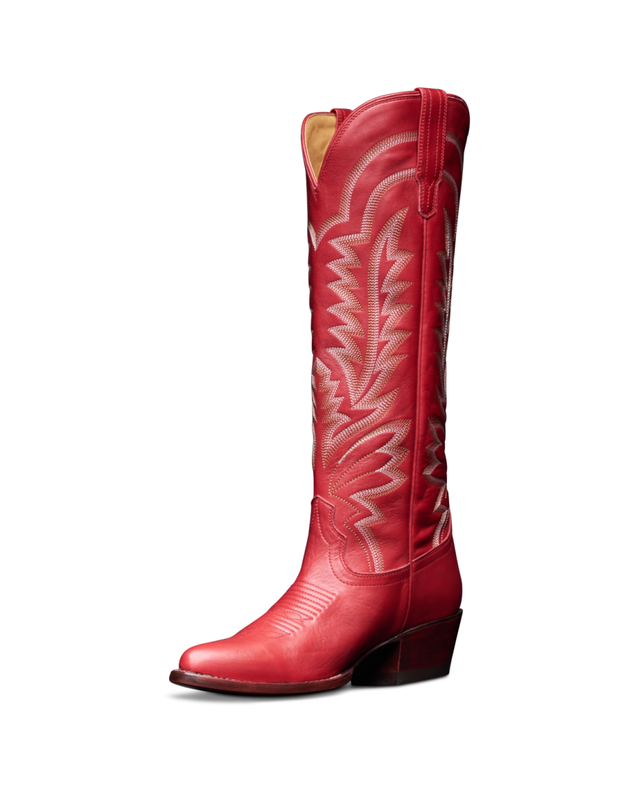 The Abby Wide Calf in Crimson Cowhide. A tall crimson cowhide leather cowboy boot with decorative white stitching, a pointed toe, and a low angled heel is shown against a plain white background.