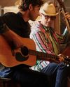 Man strumming a guitar