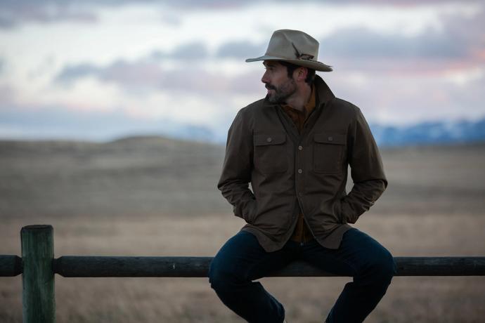 man sitting on a fence