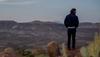 man on a rock cliff looking out