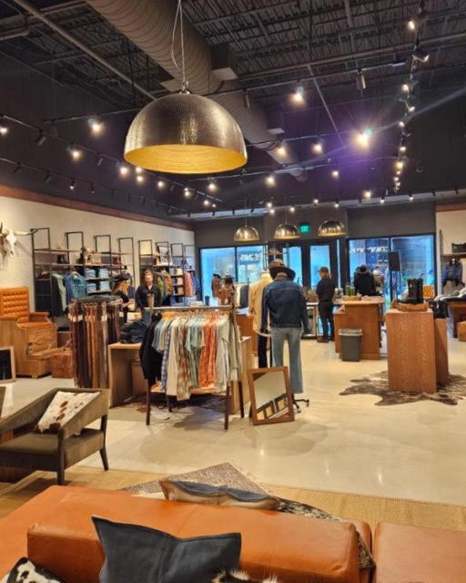 Image of the La Cantera Tecovas store. boots and clothes in the background.