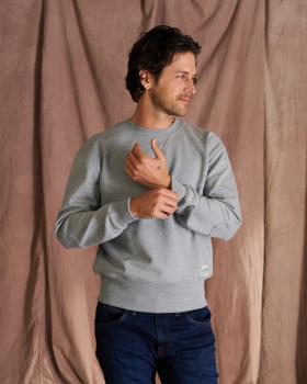 Man wearing the heather gray old school sweatshirt in a photo studio