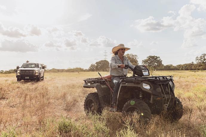 man on an atv in a field