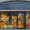 Storefront of Tecovas, featuring large glass doors and windows displaying boots and western wear. The store sign and street number 204 are visible above the entrance.