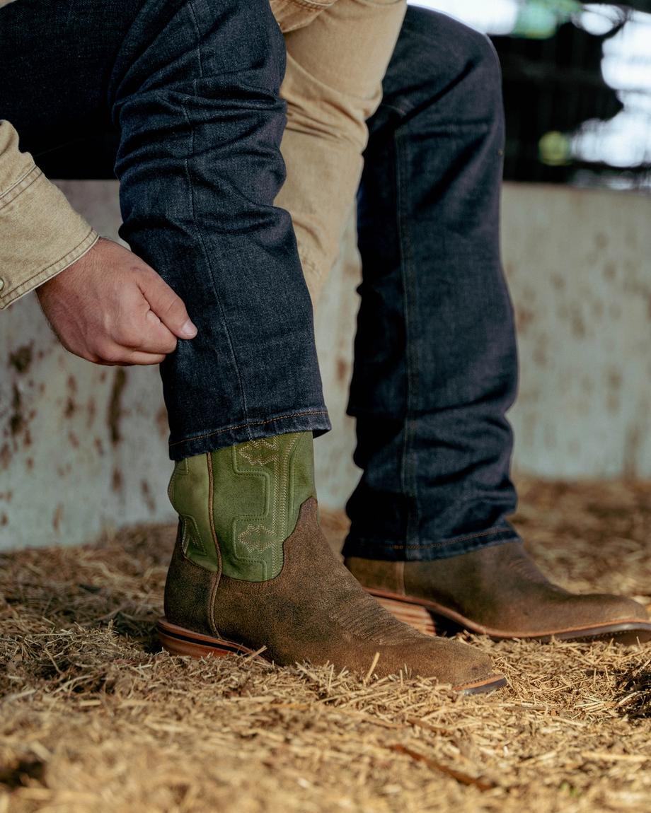 Closeup image of man wearing the Cody Sandstone on a ranch
