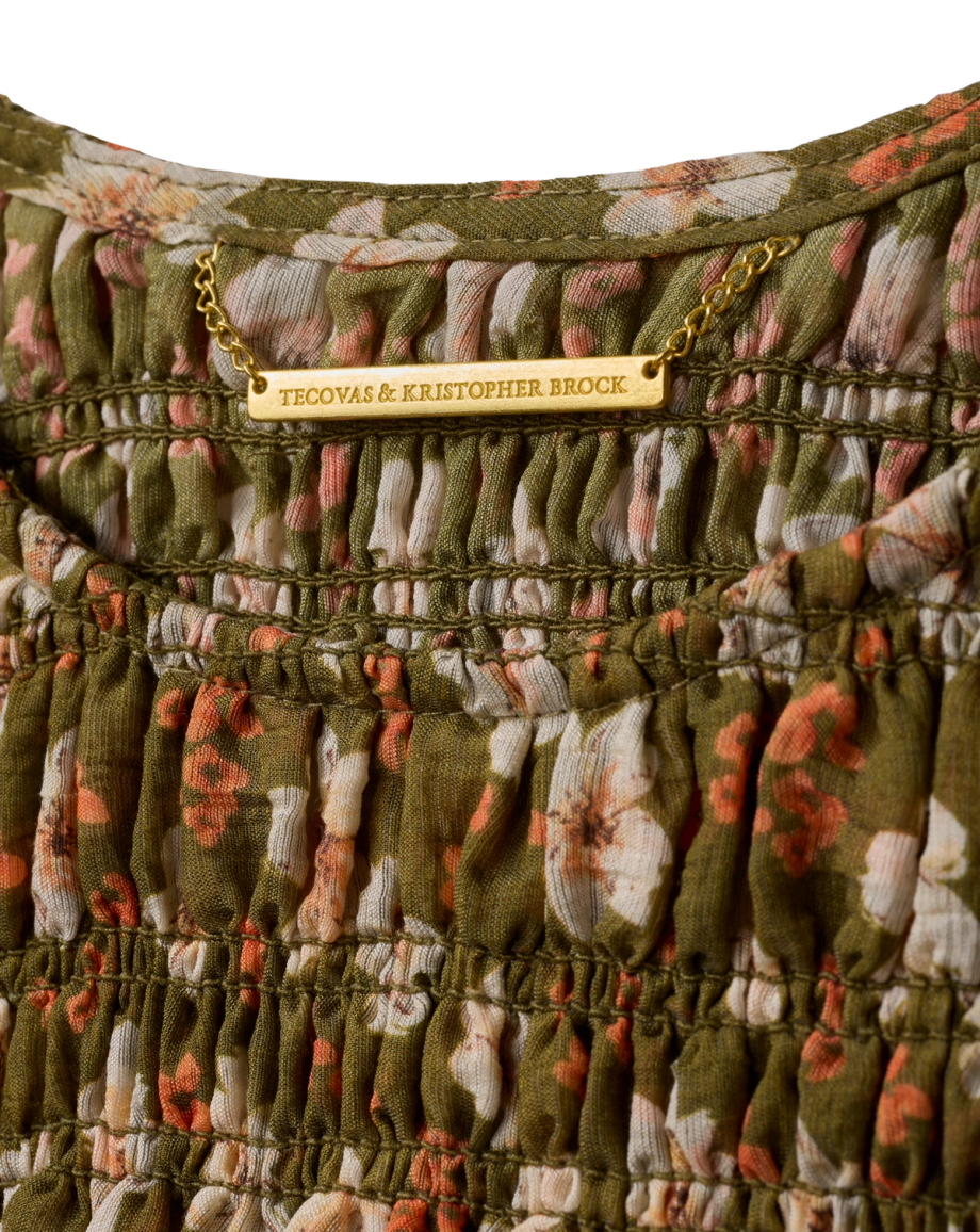 close up view of The Emma Dress by Kristopher Brock - Olive/Beige Floral Cotton Blend on plain background