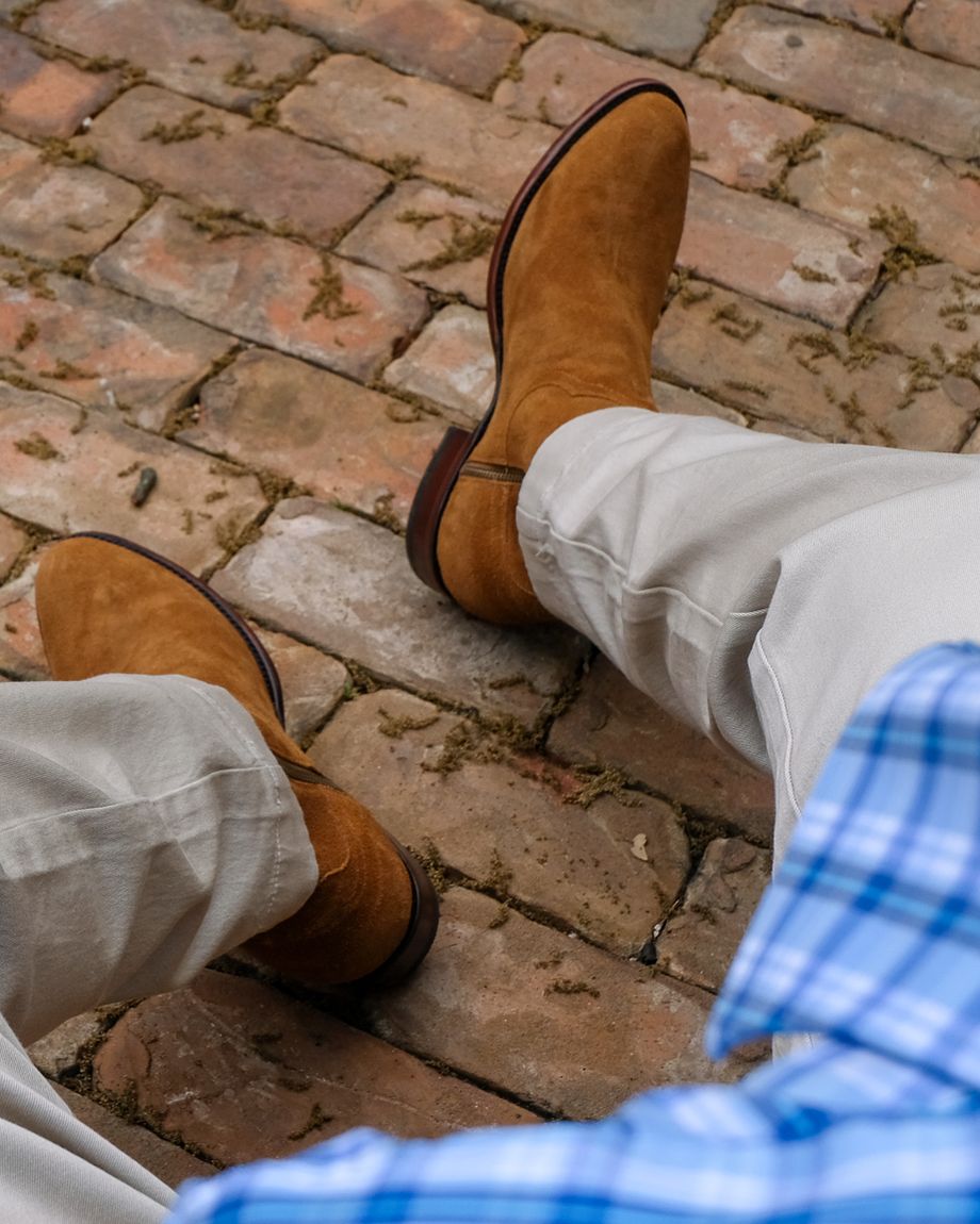 close up of Dean Honey Tan Suede cowboy boots on a man's feet