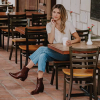 woman at a coffee table in zip boots