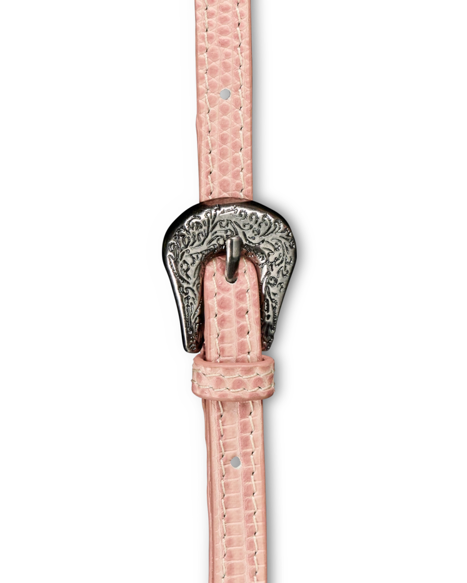 Close-up of a pink textured belt with an ornate silver buckle featuring an engraved floral pattern.