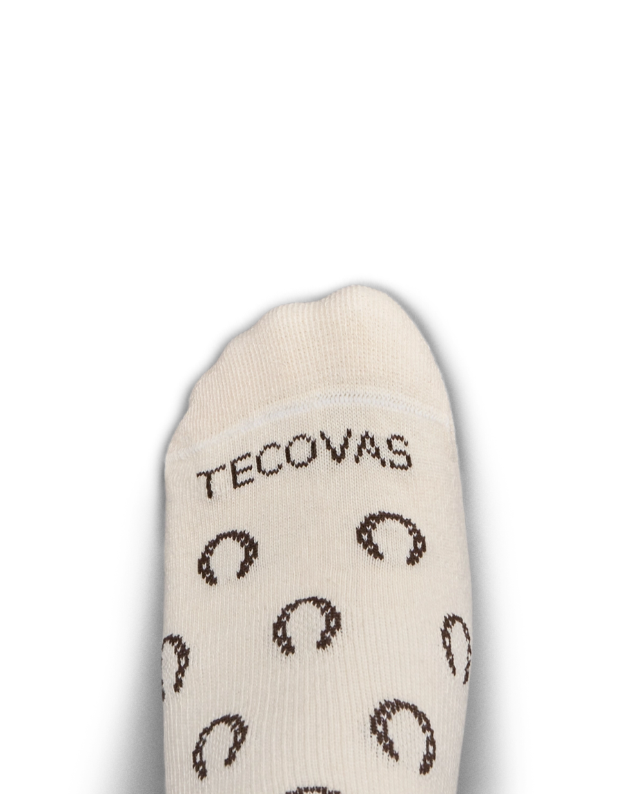 Cream-colored sock with the word "TECOVAS" and brown horseshoe patterns, shown on a white background.
