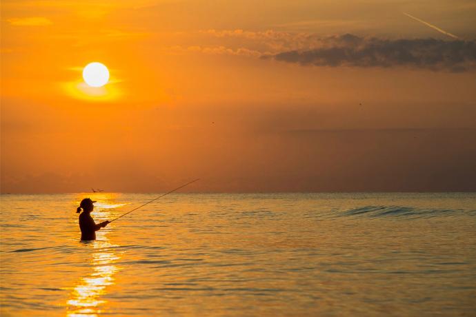 woman in water fishing