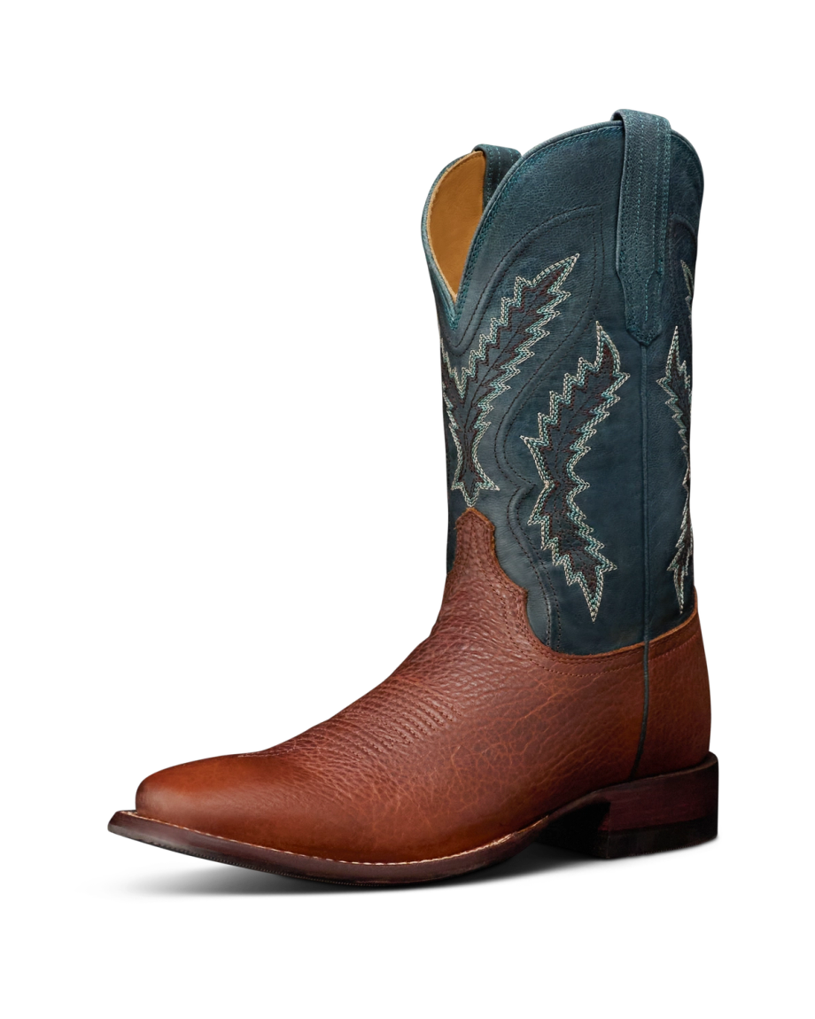 The Doc in Burnt Umber / Blue Cowhide. A brown leather cowboy boot in Burnt Umber with a textured toe and a blue cowhide shaft featuring decorative stitching, shown against a white background.