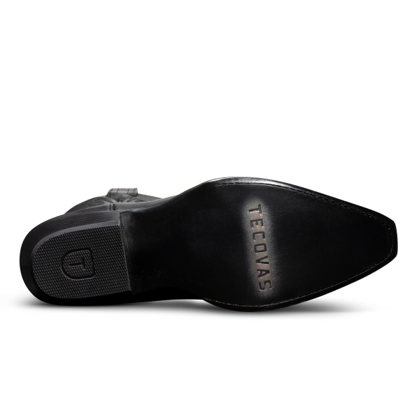 Sole of a black leather boot with "TECOVAS" engraved, featuring textured and smooth sections.